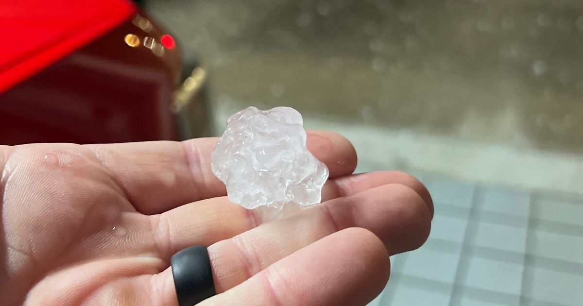 Quarter-size hail collected after a Metro Atlanta storm, shown next to a measuring tape for scale.